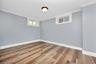 Empty room featuring crown molding and wood finished floors