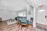 Dining room with ornamental molding, a baseboard heating unit, wood finished floors, and recessed lighting
