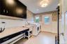 Storage cabinets, a sink and massive folding table make this mud/room - laundry center a terrific space!  It also offers direct access right to the ba