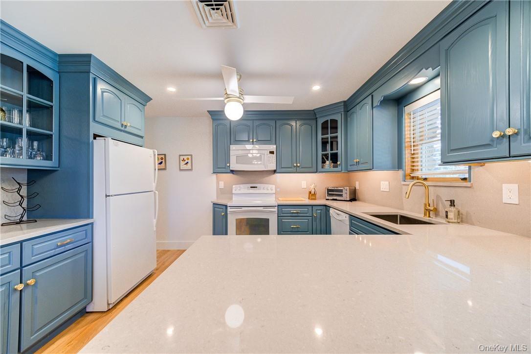 Gleaming stone countertops and a built-in coffee bar area.