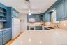 Gleaming stone countertops and a built-in coffee bar area.