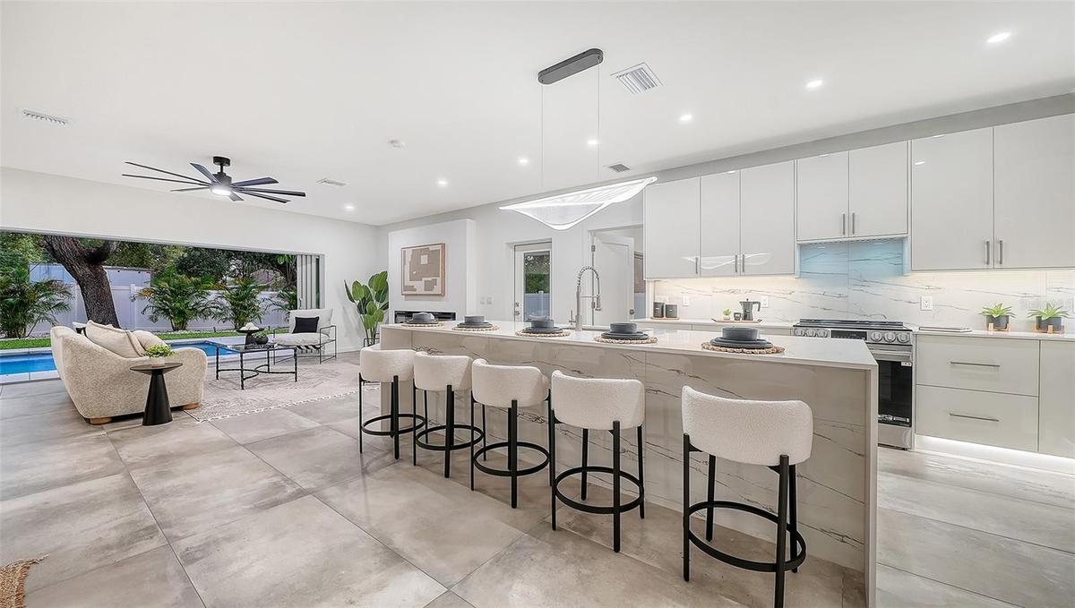 Open-concept kitchen with pool views.