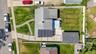 Aerial property view featuring a light gray shingle roof and a detached garage