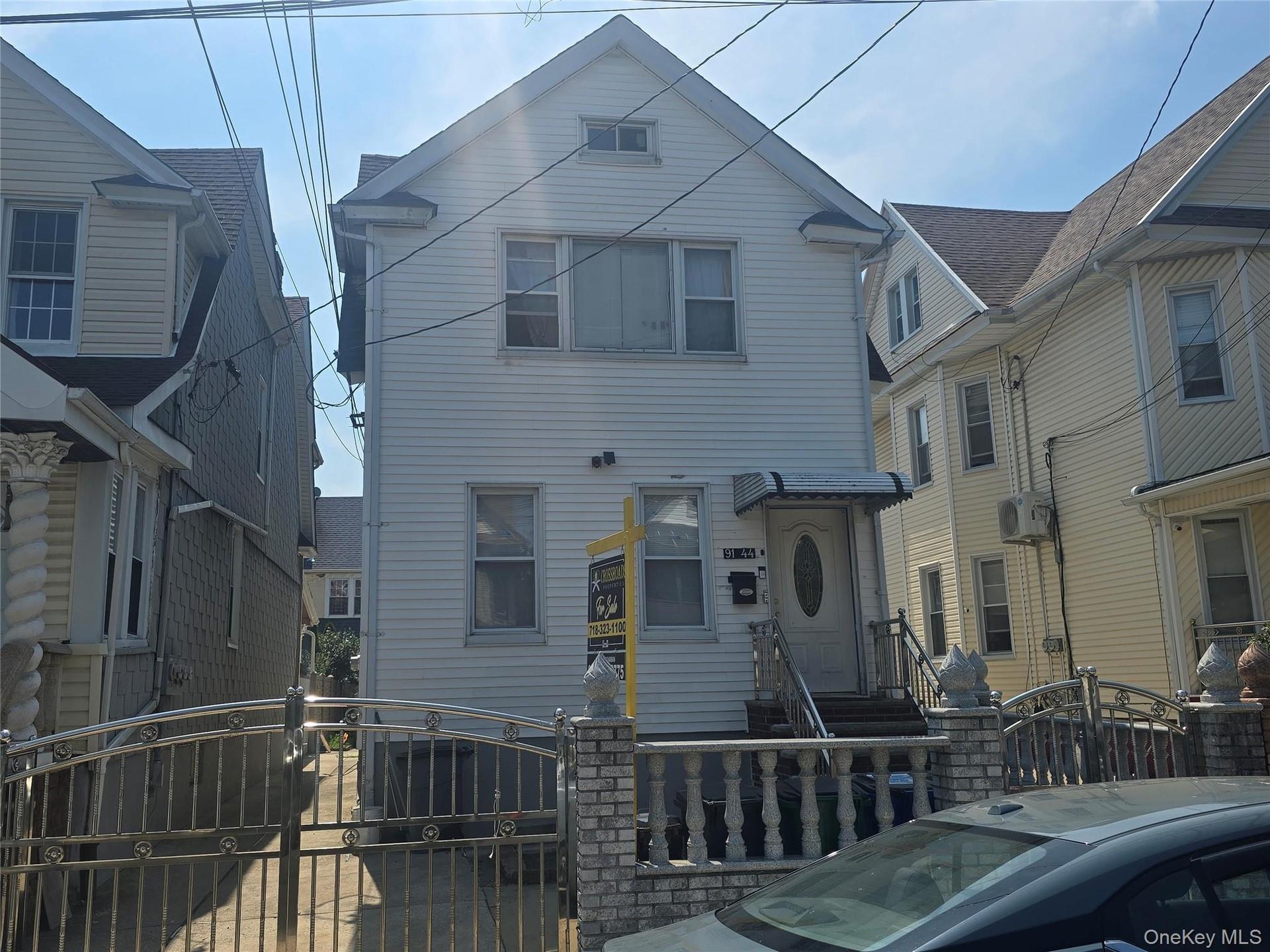 Siding exterior with dormer window and covered entryway