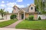Beautifully Updated and Expanded Cape with Oversized Portico, Stone, Stucco, Vinyl Siding and newer architectural shingle roof.