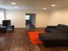 Living area with recessed lighting, plenty of natural light, dark wood-type flooring, and baseboards