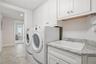 Laundry room with built-in cabinetry and utility sink.
