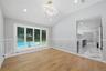 Open concept dining area featuring vaulted ceilings, recessed lighting, and wood-finish flooring