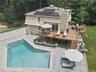 side of the house with pool patio, pool, wrap around deck.