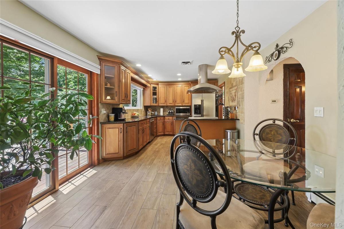 Eat-in kitchen with glass slighting door to off kitchen balcony.