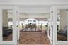 The French doors invite you to a fully enclosed paver patio, offering a versatile space for entertaining, dining, or simply enjoying the Florida lifes