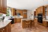 Wood Mode Cabinetry with a granite countertop on the island