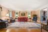 Formal living room with pocket doors flows into the Library
