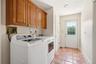 Separate laundry area with access to backyard, 2 car garage and first floor bedroom
