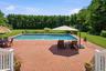 Brick terrace surrounding the pool.