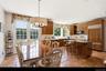 Country kitchen with eat in breakfast table and French doors leading to the deck.