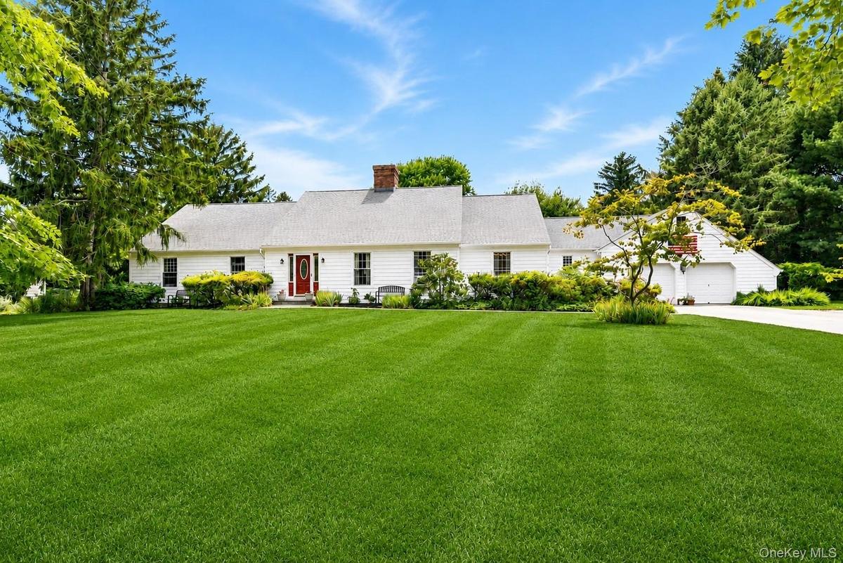 Classic and inviting front exterior welcomes you with timeless curb appeal, mature landscaping and a picturesque setting overlooking the golf course. 
