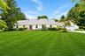 Classic and inviting front exterior welcomes you with timeless curb appeal, mature landscaping and a picturesque setting overlooking the golf course. 