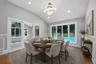 Open concept dining area featuring vaulted ceilings, recessed lighting, and wood-finish flooring