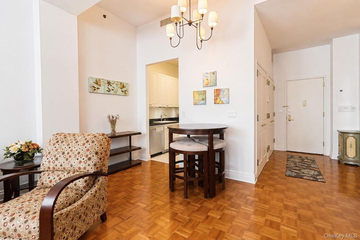 Another view from the living room showing entry to apartment and entry to kitchen