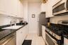 Galley Kitchen with Stainless Steel appliances , Granite counter tops and plenty of cabinetry for storage