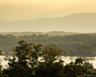 Property view of mountains with a water view and a forest view