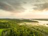 Aerial view at dusk featuring a water view