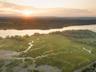 Aerial view at dusk featuring a water view