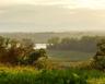 Property view of mountains with a water view and a view of trees