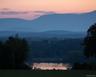 Property view of mountains featuring a water view and a forest view