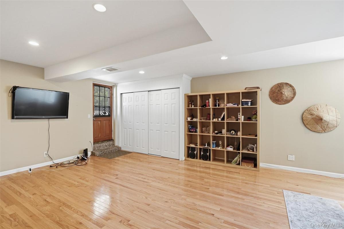 Finished basement with hardwood floors.