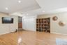Finished basement with hardwood floors.