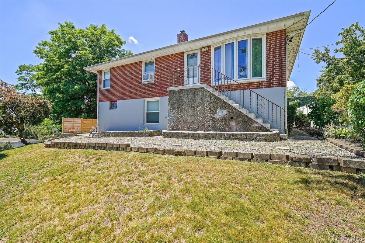 Front view of house with sloped yard.