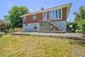 Front view of house with sloped yard.