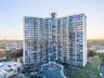 Property at dusk featuring a view of apartment building / complex