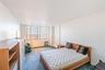 Carpeted bedroom featuring a textured ceiling and track lighting