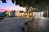 Twilight front with pavered drive and walkway