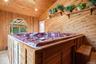 ...while the large window brings in natural light & outdoor views.  The room also features an independent electric baseboard heater, motorized skyligh