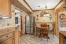 Near the refrigerator, is an inviting dining area  that comfortably accommodates everyday meals and casual gatherings.