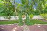 a paver stone walkway through the arbor...