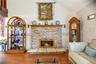The focal point of the living room is the cultured stone faced, wood burning fireplace, with its wood mantle & raised hearth.