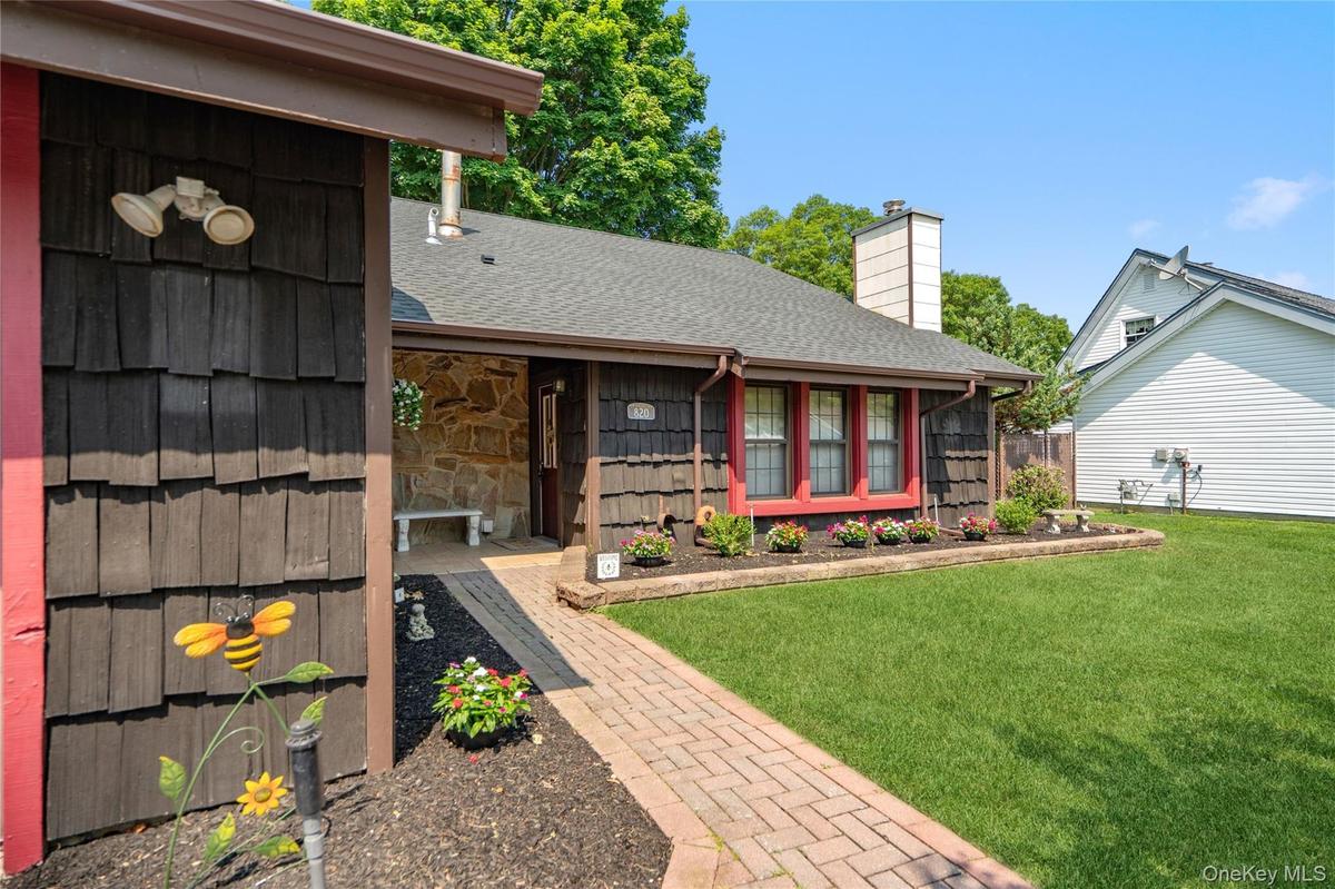 The paver-stone walkway leads you off the doublewide driveway and to your front door.