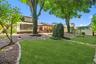 This peaceful backyard retreat features mature shade trees...