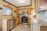 It is a great working kitchen with a full array of stainless steel appliances, lots of storage in the base & upper cabinets, while providing plenty of