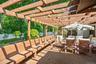 This spacious wood deck spans between the sun room and the sauna/hot tub room.  It offers plenty of seating and an outdoor dining space.