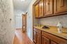 This hallway just off the kitchen, leads to the laundry & utility room, and down to the home's front entry way; but it is punctuated by this hallway b