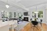 Open-concept Family room with 2nd fireplace, coffered ceilings and doors out to deck.