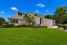 Contemporary exterior design with an arched entry and an attached garage