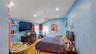 Vaulted ceiling room featuring hardwood flooring and recessed lighting