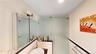Bathroom featuring a frameless frosted glass shower enclosure, contemporary vessel sink, wall-mounted medicine cabinet with mirrored doors, and recess